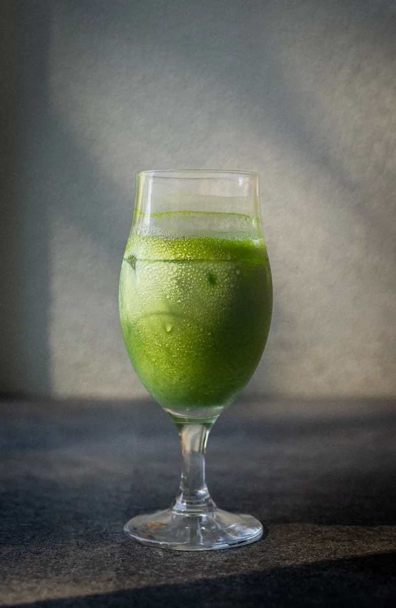 Representative vivid green iced matcha in a stemmed glass
